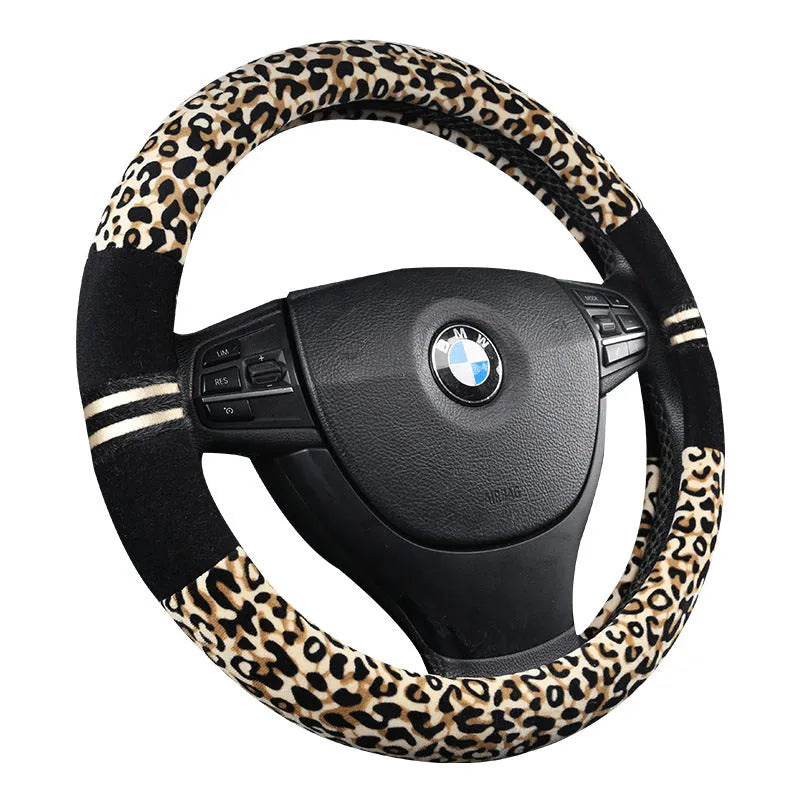 Winter plush car steering wheel cover in beige with leopard grain pattern on a GM steering wheel
