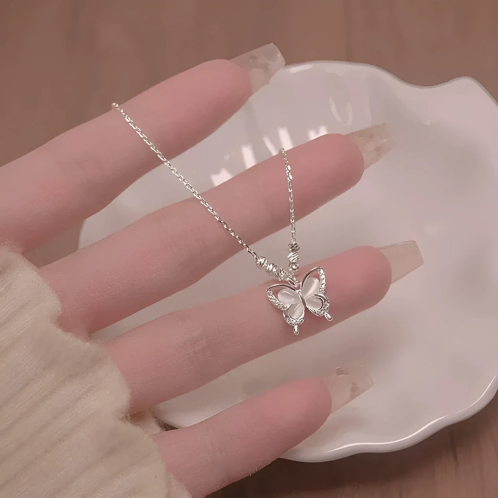 Women's silver butterfly necklace with a cross chain, showing the 925 silver pendant and adjustable length.
