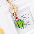 Green zinc alloy watermelon keychain on a key ring, showing detailed fruit shape.
