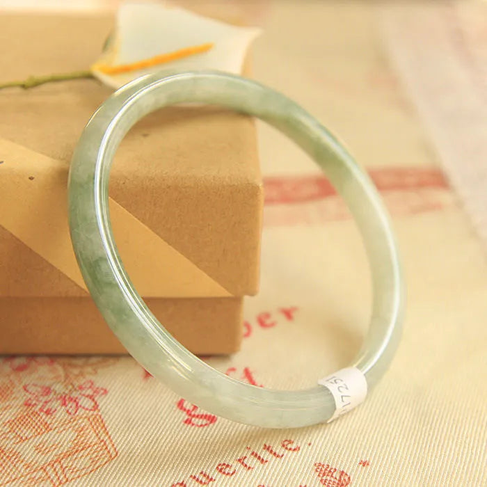 Green jade waxy Chinese style bracelet with geometric pattern showing 10mm width and adjustable sizing