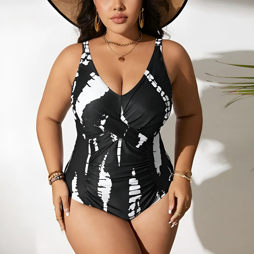 Black Siamese colour matching one-piece swimsuit on a hanger, showing sleeveless design.