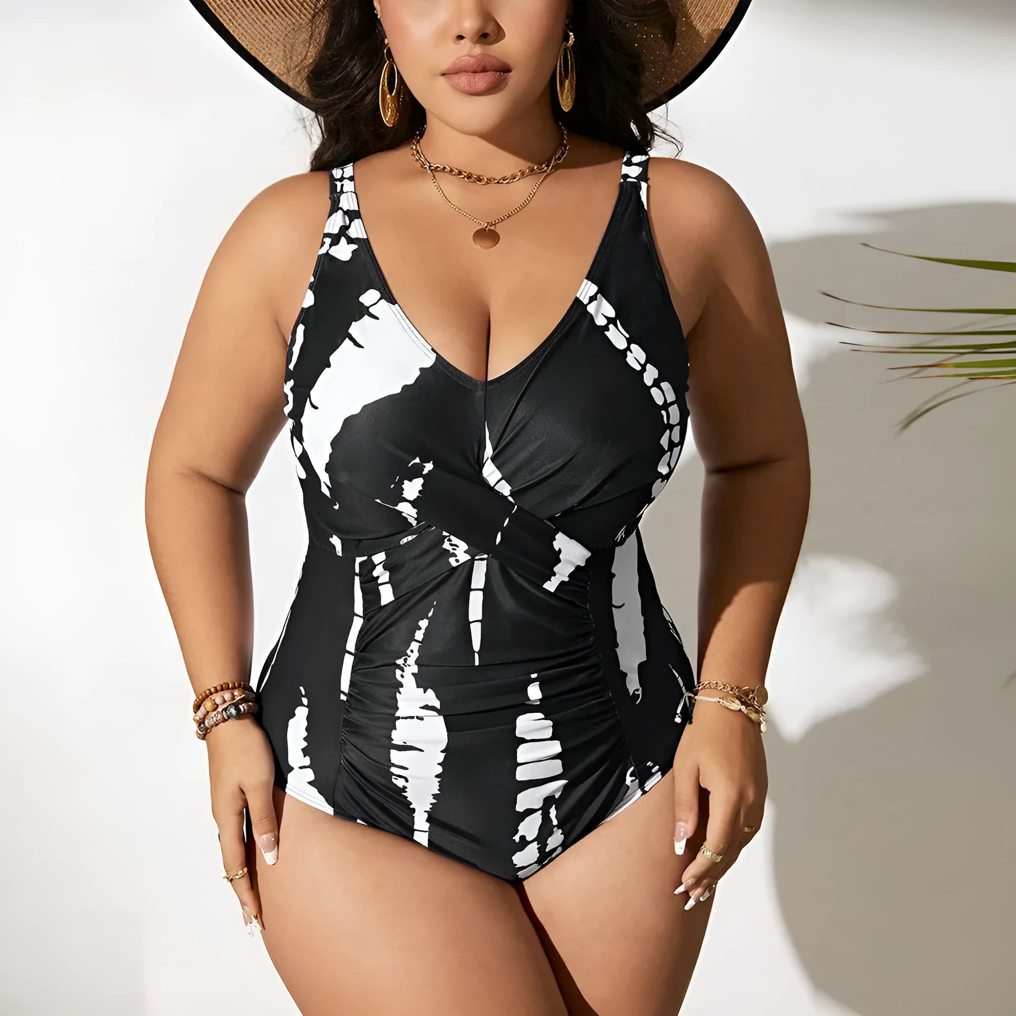 Black Siamese colour matching one-piece swimsuit on a hanger, showing sleeveless design.