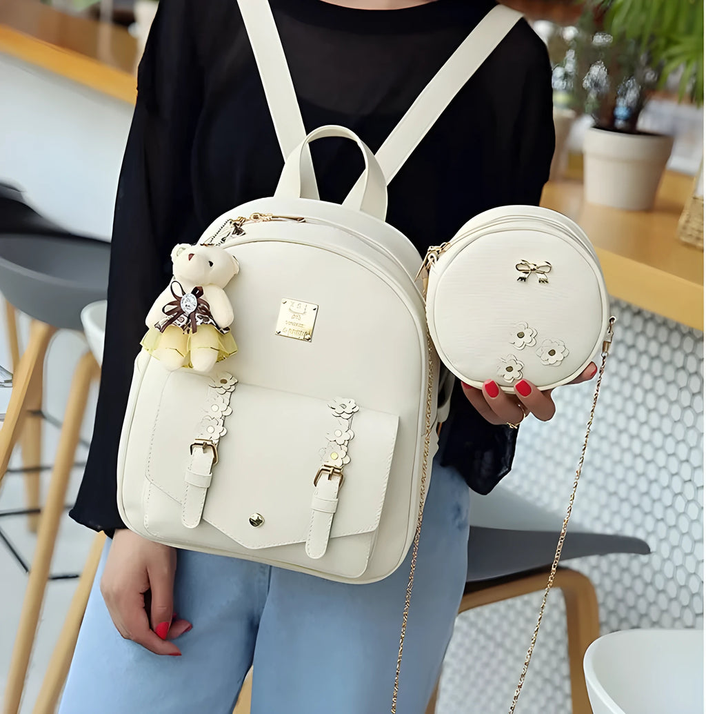 Women's 3-piece leather bag set showing backpack, shoulder bag, and card wallet with floral design