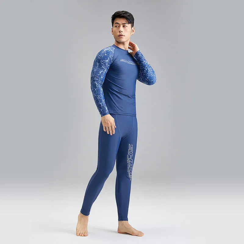 Men's dark blue patterned nylon swimwear set consisting of a top and trousers.