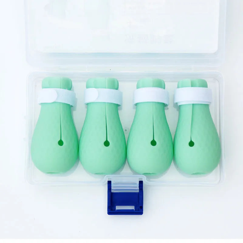 Four green silicone cat paw covers for anti-scratch protection during washing and medication
