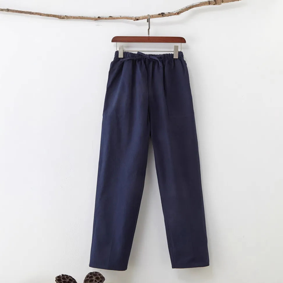 Men's beige pure cotton casual trousers with a drawstring waist on a hanger.