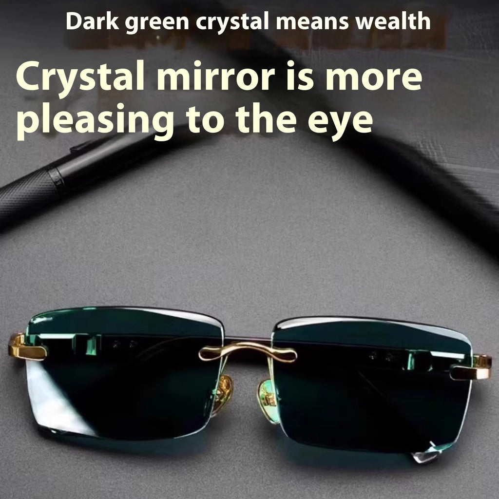 Frameless sunglasses with dark green crystal lenses showing a decorative wealth attracting pattern.