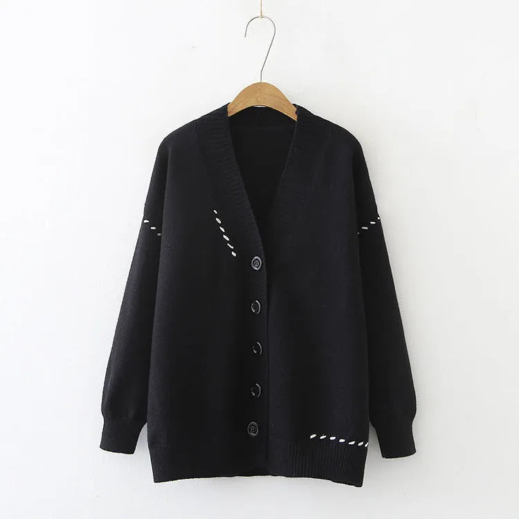 Women's loose-fit knitted cardigan coat in black, shown as a long-sleeve layering piece.