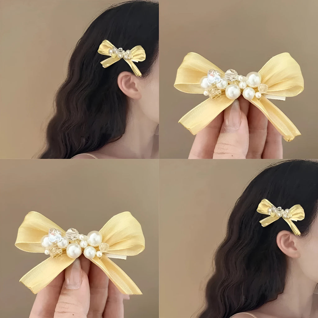Yellow bow hair clip with rhinestone pearl accents and duckbill clip design