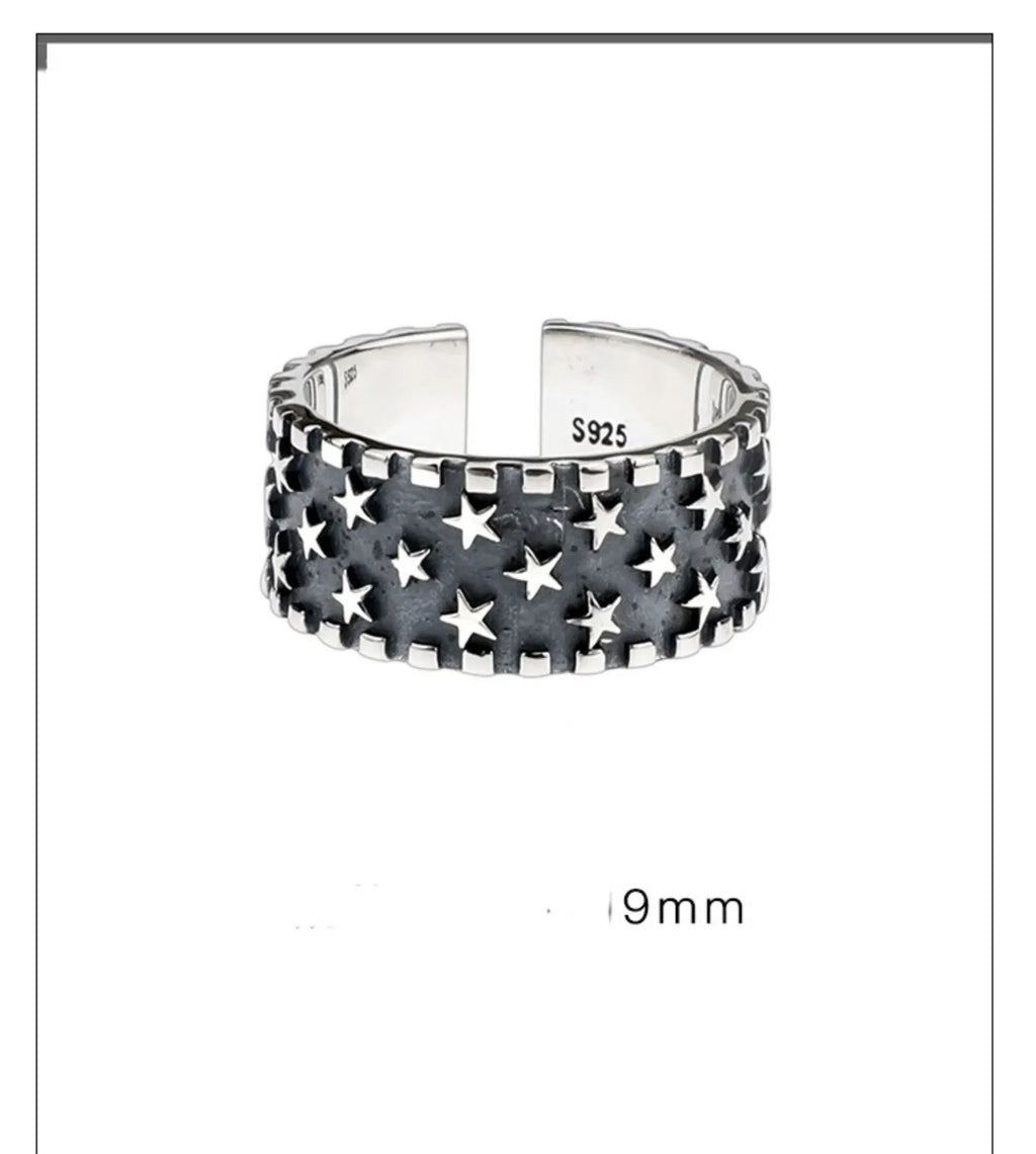Adjustable opening sterling silver ring with a multi five-pointed star geometric pattern.