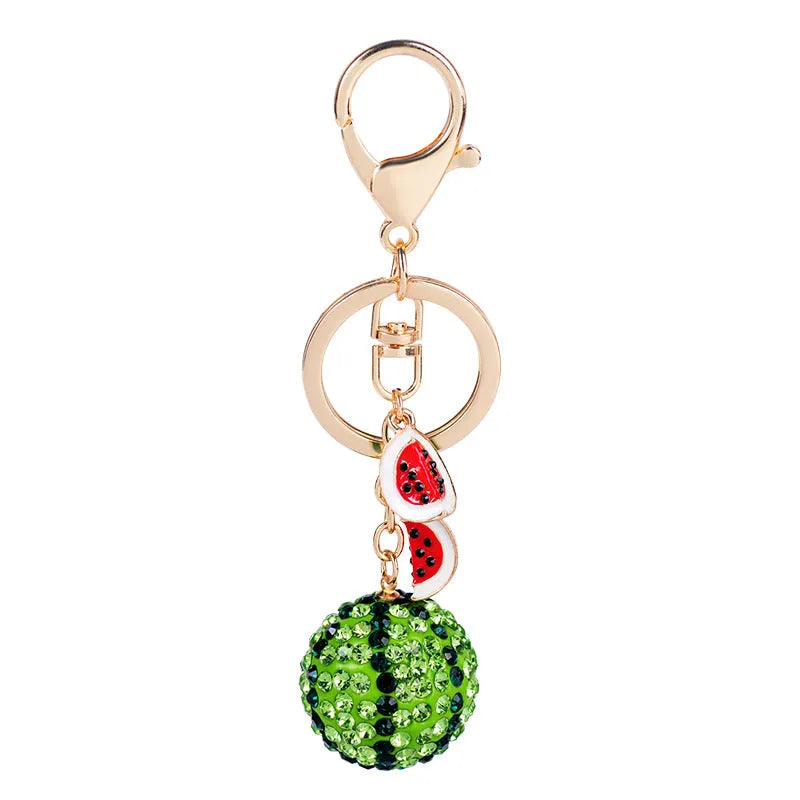 Green zinc alloy watermelon keychain on a key ring, showing detailed fruit shape.