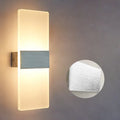 Modern acrylic LED wall lamp in silver finish showing warm light illumination