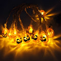 Halloween LED string lights with pumpkin, bat, and ghost pendants on a white wire
