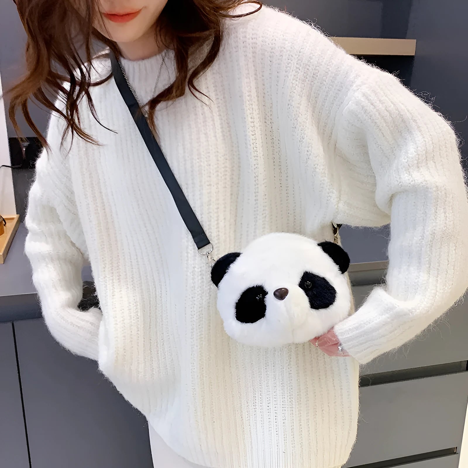 Soft plush cylindrical panda head crossbody bag with a shoulder strap.