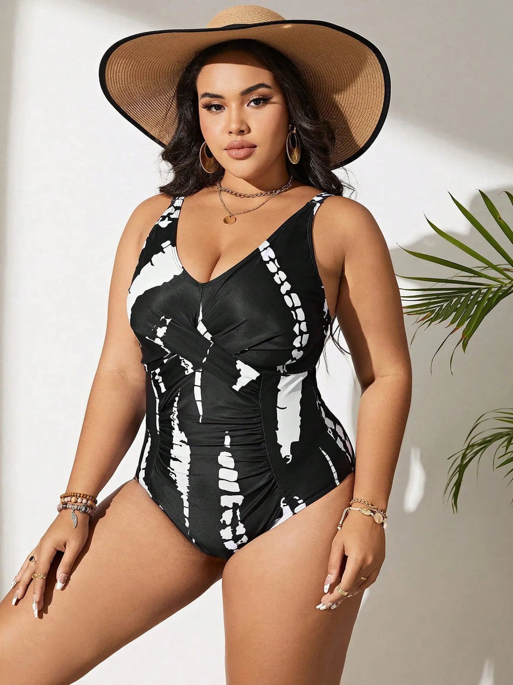 Black Siamese colour matching one-piece swimsuit on a hanger, showing sleeveless design.
