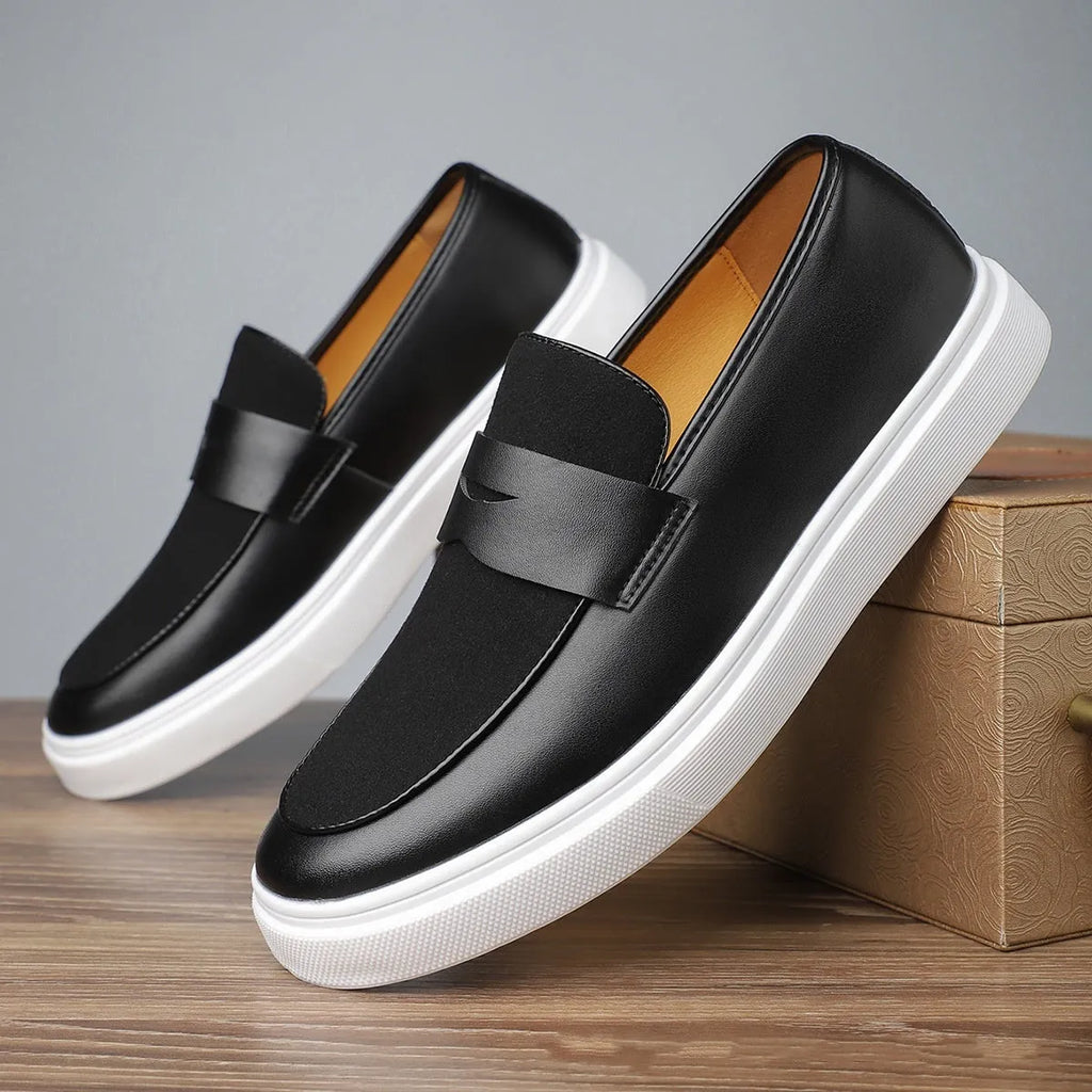 Black men's casual slip-on shoes with tassel detail and round toe on a gommino rubber sole
