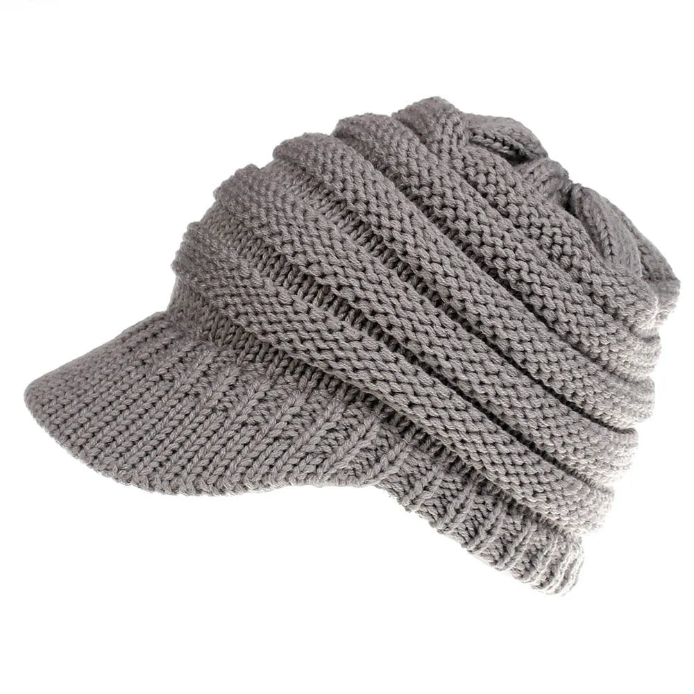 Women's knitted acrylic beanie hat designed for wearing with a ponytail or bun.