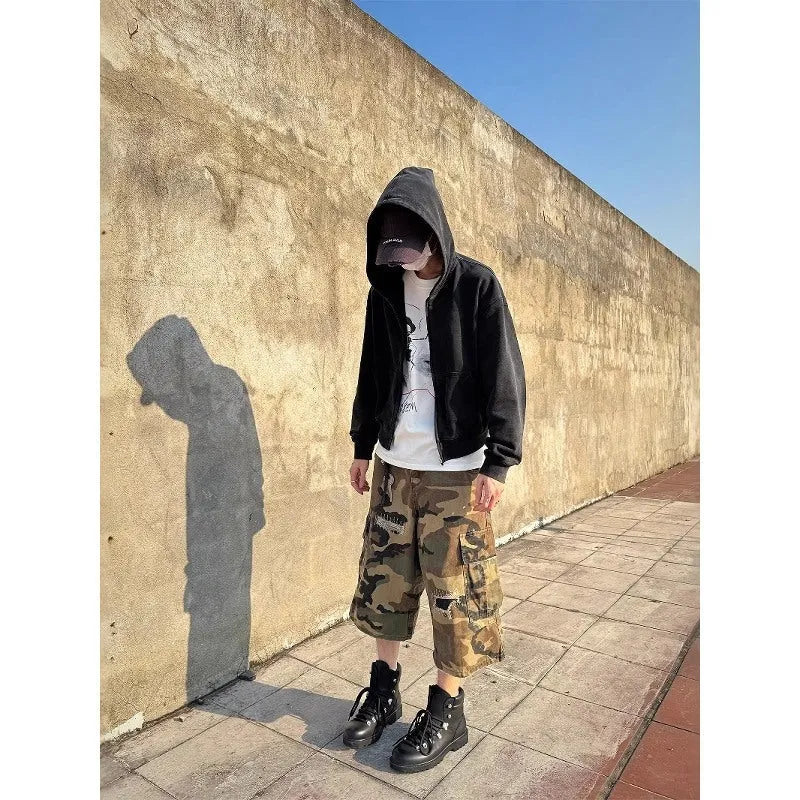 Men's loose-fit camouflage coloured cropped jeans with ripped details and straight-leg cut.
