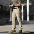 Loose multi-pocket men's cargo pants in khaki cotton blend fabric with multiple pockets and drawstring waist