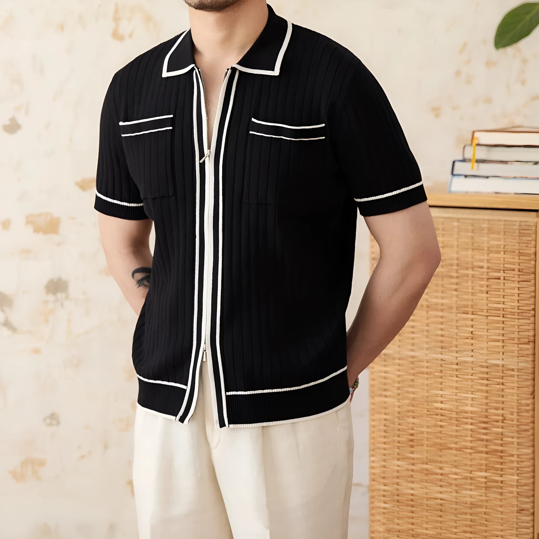 Slim-fit black knitting polo shirt with a lapel collar and short sleeves on a neutral background.