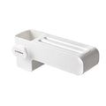 White plastic wall-mounted magnetic knife rack holding several kitchen knives