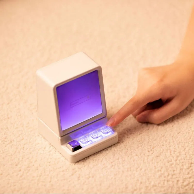 Portable computer-shaped Bluetooth speaker in light grey with lighting and voice prompt function