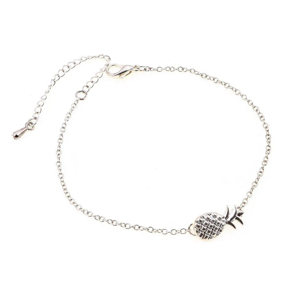 Women's alloy bracelet with a simple pineapple charm in a choice of gold or silver metallic finish.