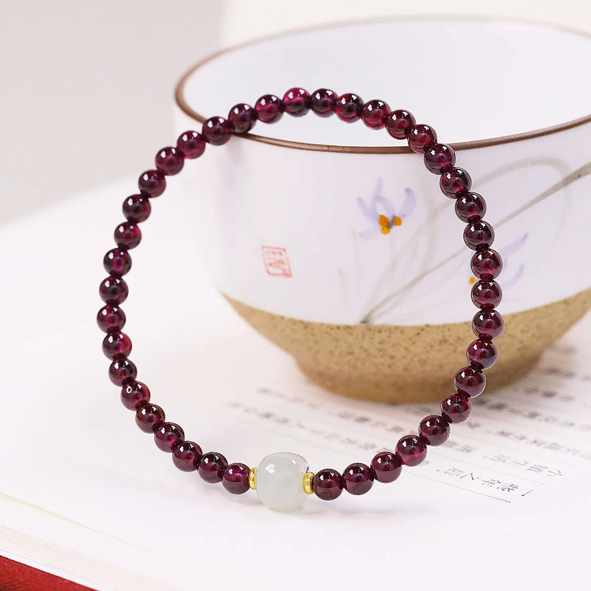 Simple U-shaped natural garnet bracelet for women, shown in garnet and dream garnet colour options with 4mm and 6mm bead sizes.