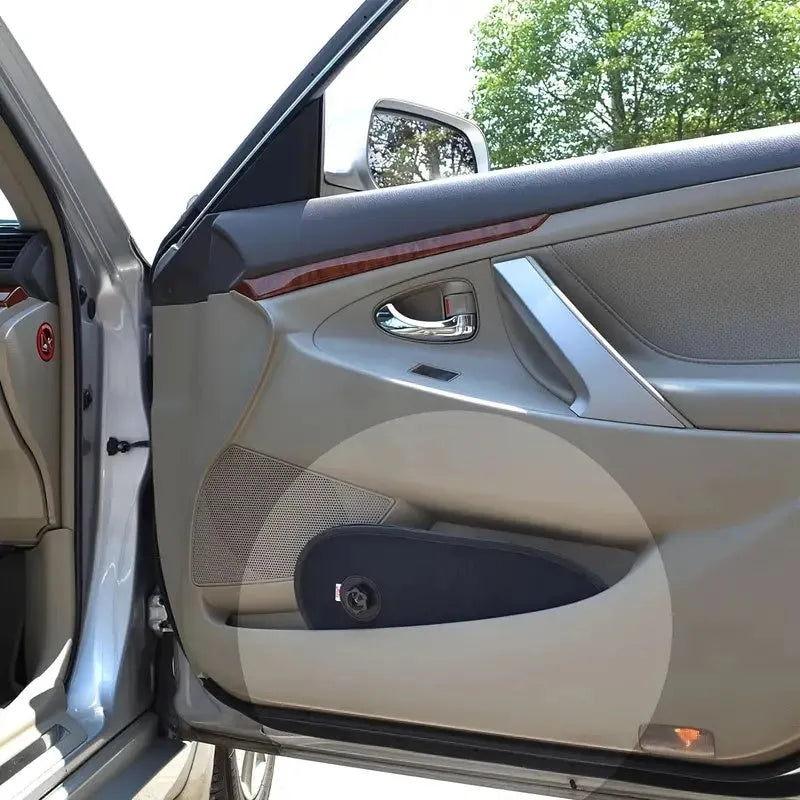 Black stretchy car side window sunshade for baby with suction cups attached to glass.