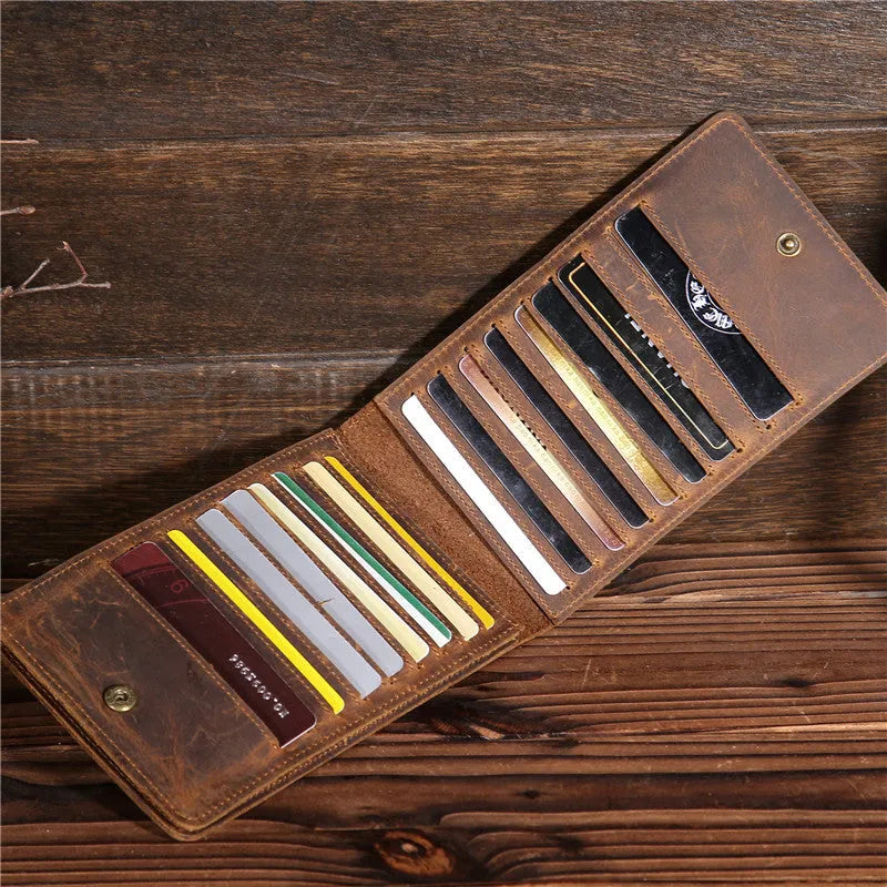 Men's long leather wallet open showing 18 card slots, cash compartment, and phone pocket.
