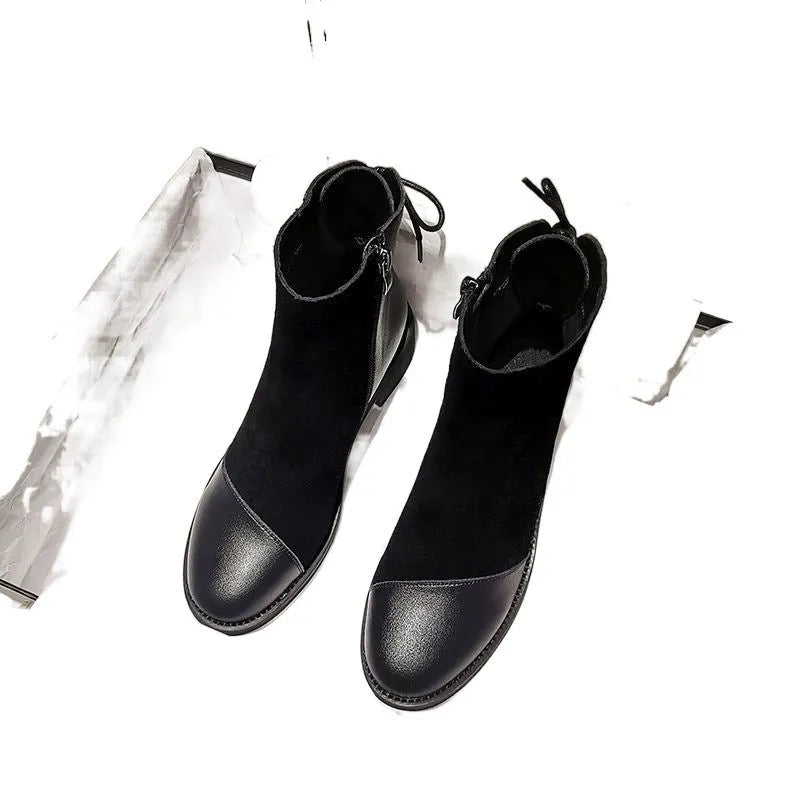 Black women's knee-high Martin boots with side zip, round toe, and chunky heel on a non-slip rubber sole.