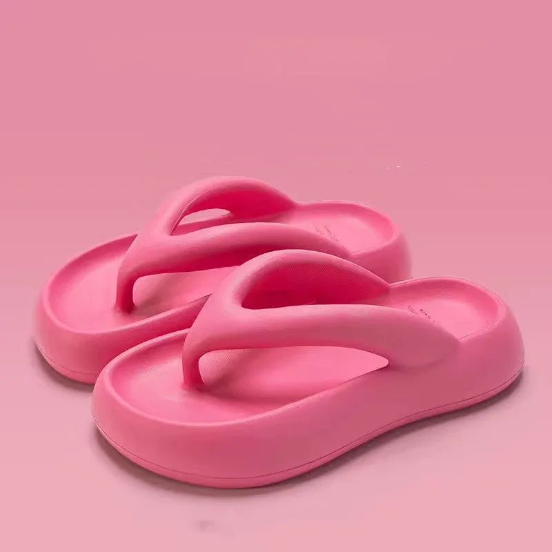 A pair of solid colour thick-soled EVA flip-flops with a bow detail on the strap.