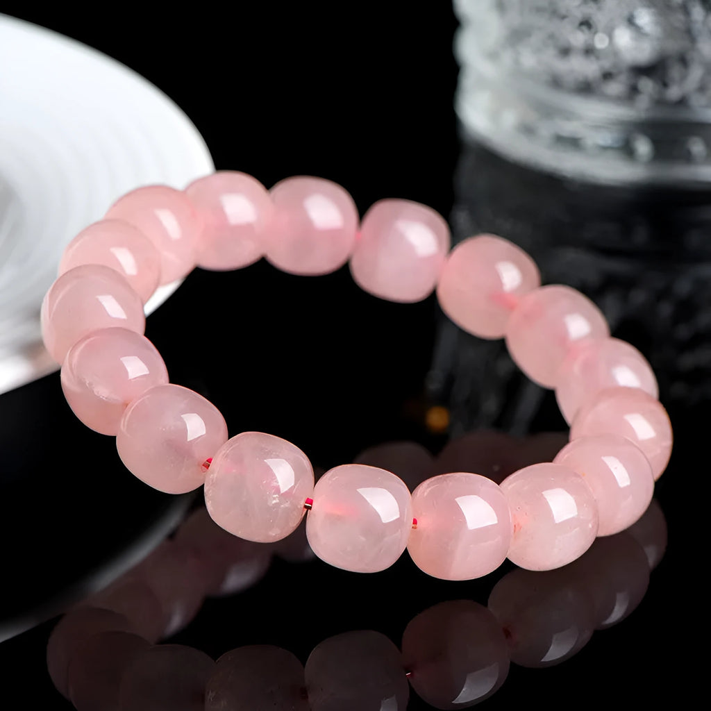 Pink crystal barrel bead bracelet with geometric design and polished finish