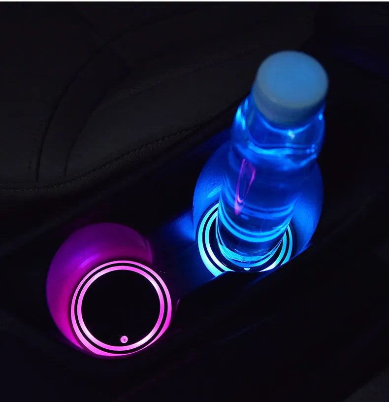 Colourful LED light-up coaster for car cup holder with USB cable, showing multiple light colours.
