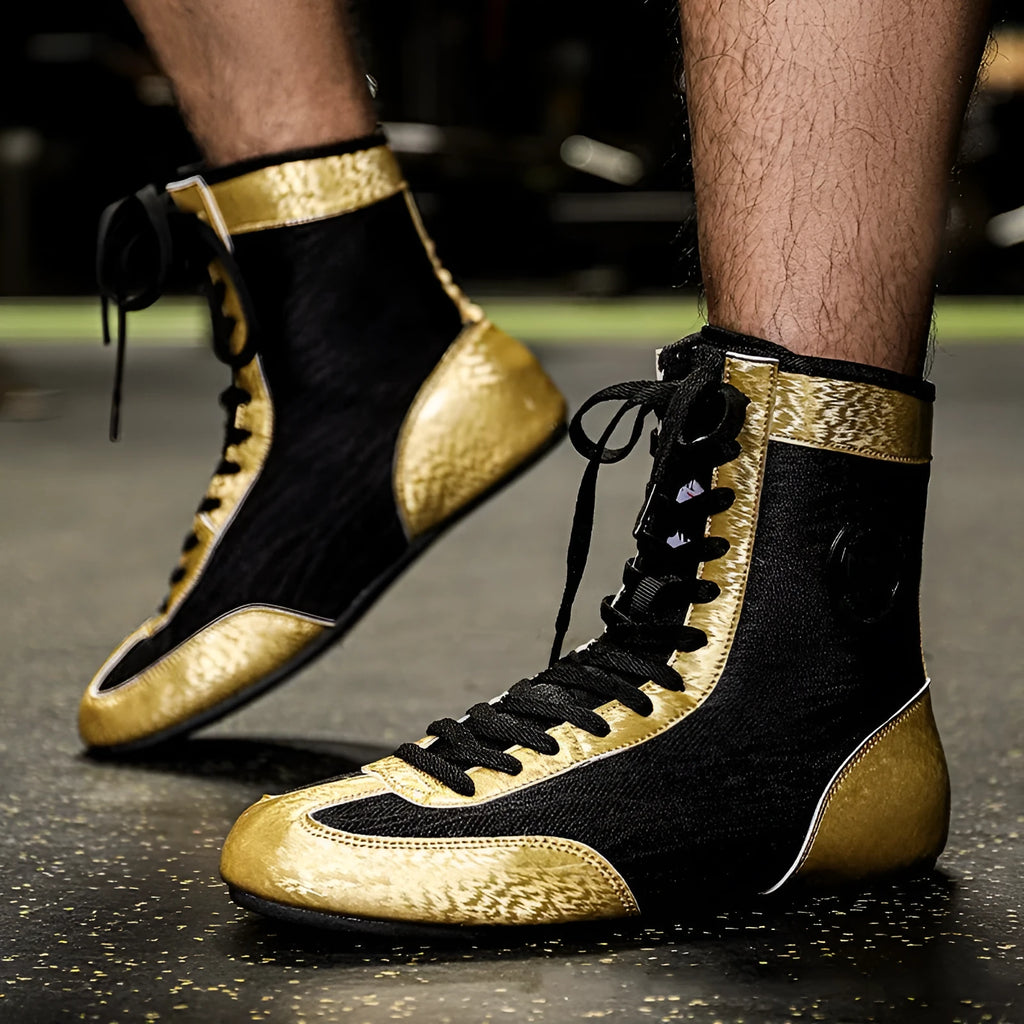 Professional black and gold mesh boxing shoes with non-slip soles for indoor training.