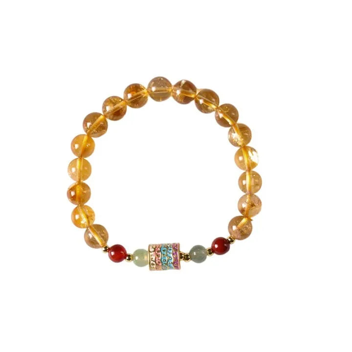 Yellow citrine prayer wheel bracelet with 8mm beads on wrist