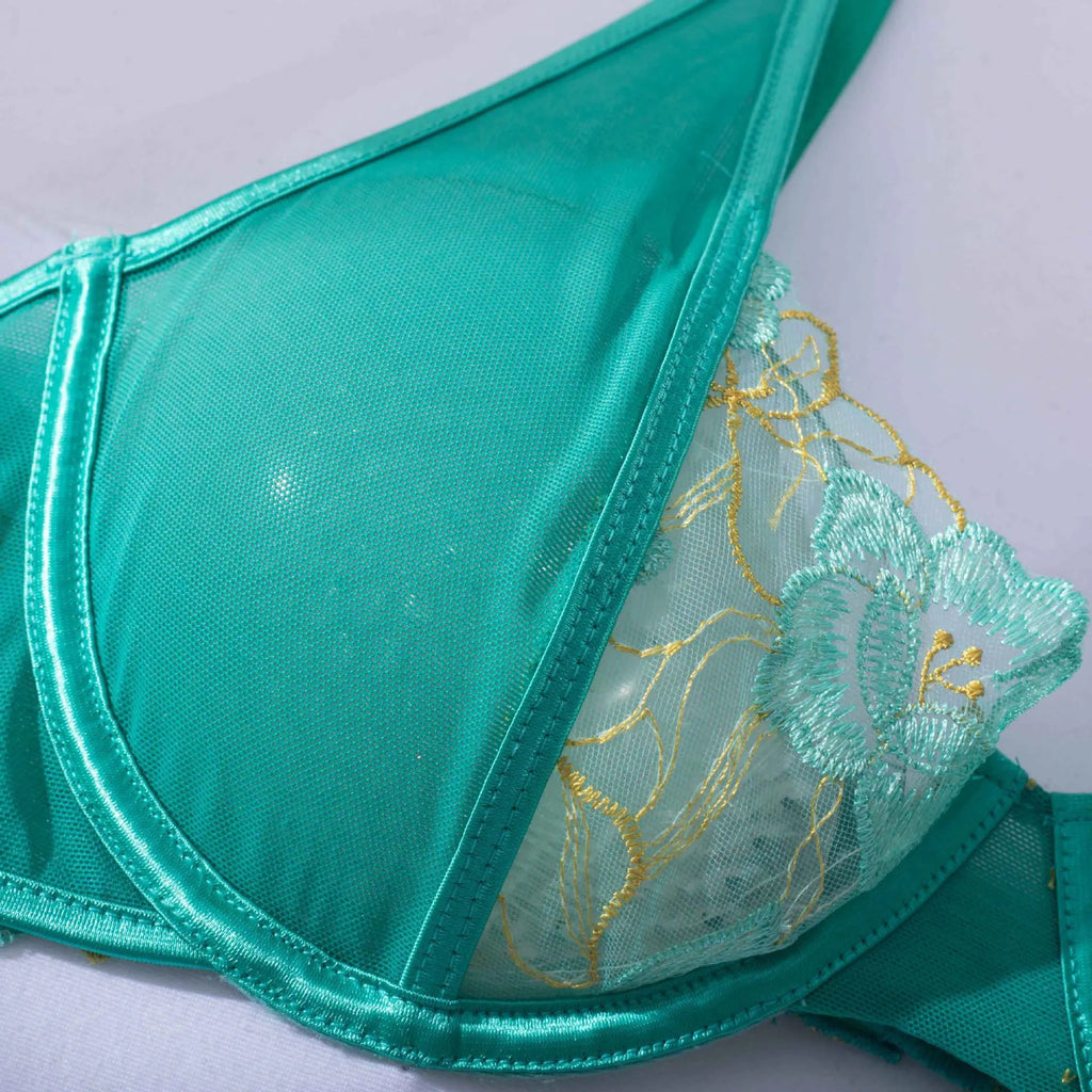 Light green women's bra set with embroidery detailing showing front view of three-point style construction