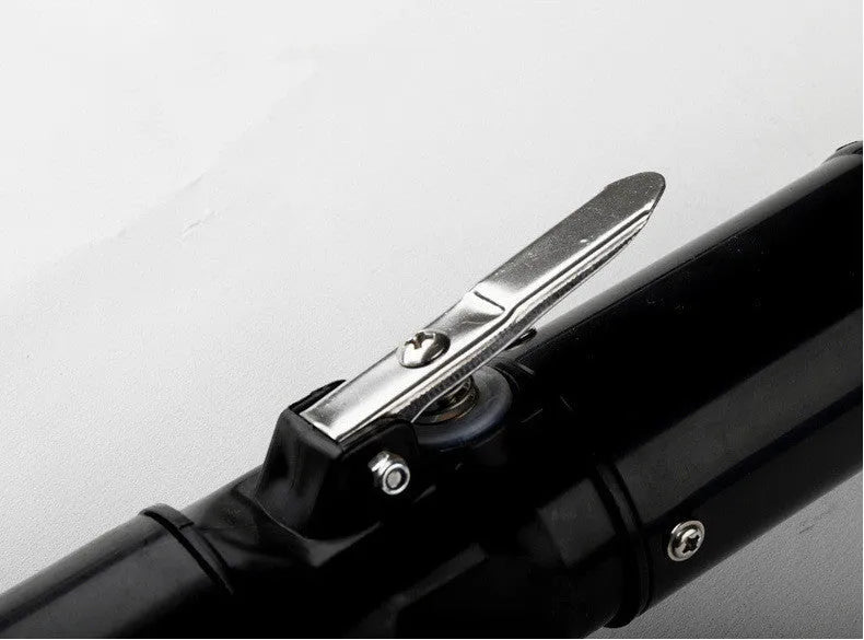 Black electric fish scale descaling tool with brush head on white background