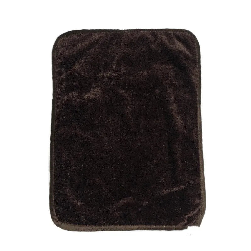Waterproof urine proof pet blanket in grey with black and white bottom on a kennel bed