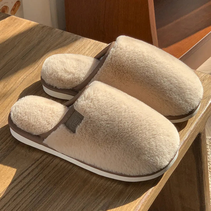 Pair of solid-colour plush winter slippers with a PVC upper and non-slip sole.