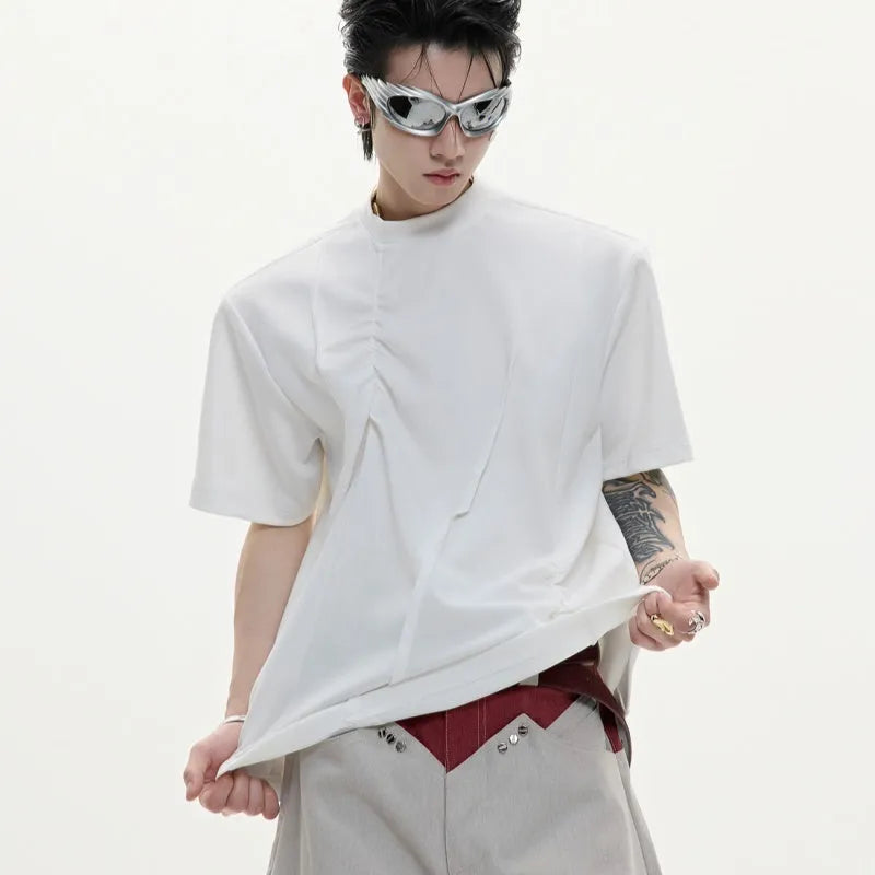 Men's black cotton t-shirt with three-dimensional pleats and a round neck, laid flat.