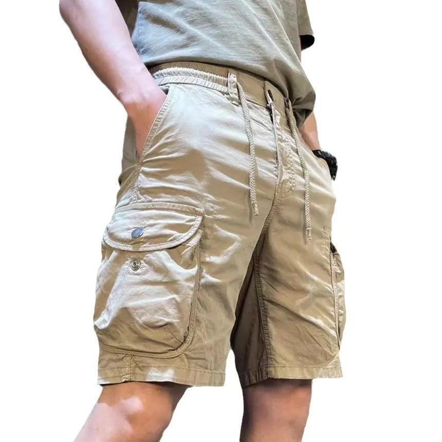 Loose straight-leg multi-pocket overalls in khaki, showing Korean-style casual fit.