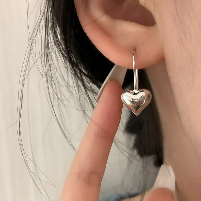 Three-dimensional glossy heart earrings with Korean style design in silver tone