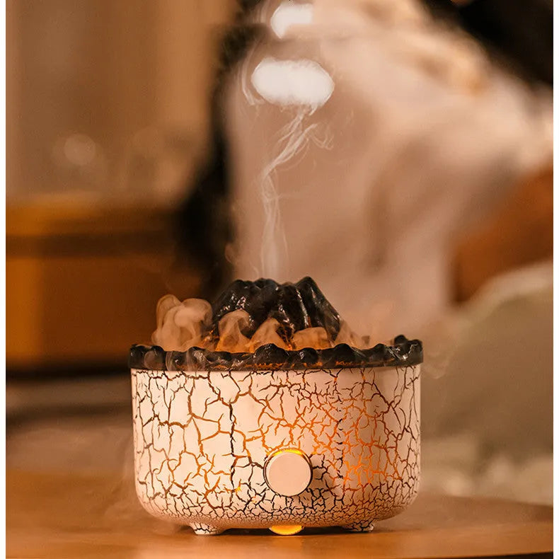 Column-shaped volcano humidifier diffuser emitting coloured mist and LED light flame effect.