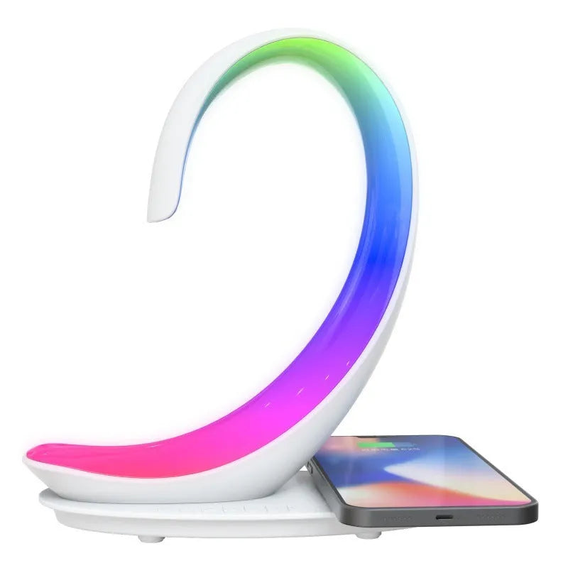 White swan-shaped desk lamp with wireless charging pad and Bluetooth speaker providing colourful ambient lighting