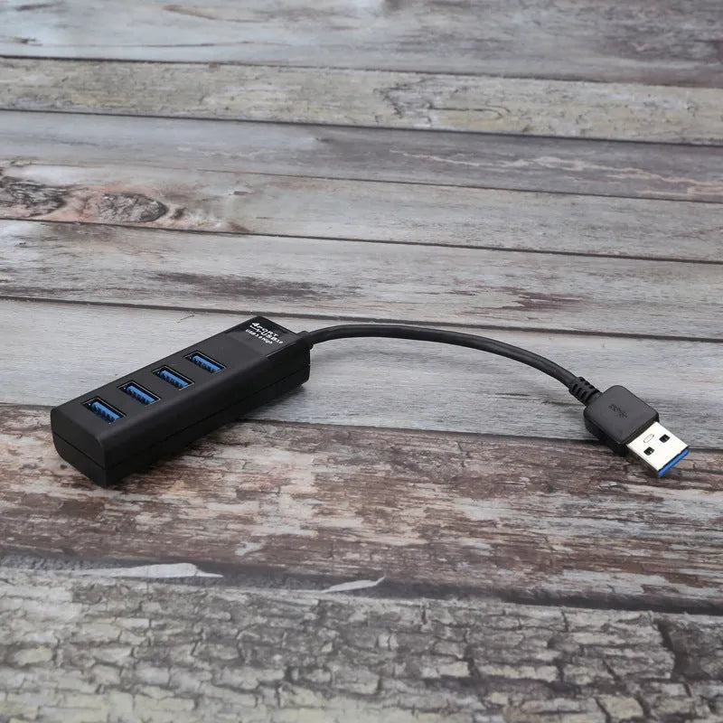 Black USB 3.0 hub with four ports, a 30cm cable, and LED indicator lights.