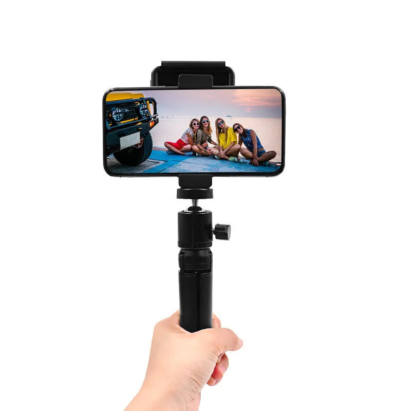 Silver aluminium alloy handheld phone mounting bracket for table top tripods, shown next to an iPhone.