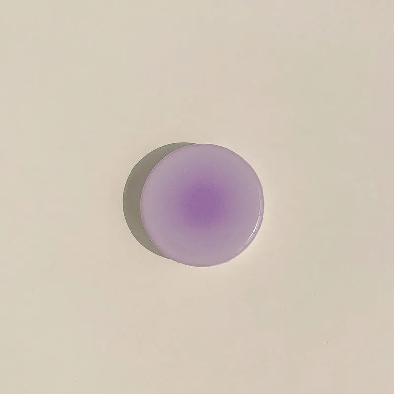 Yellow and purple gradient silicone iPhone case with a retractable viewing stand extended.