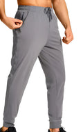 Men's loose fit solid colour casual polyester trousers on a hanger.