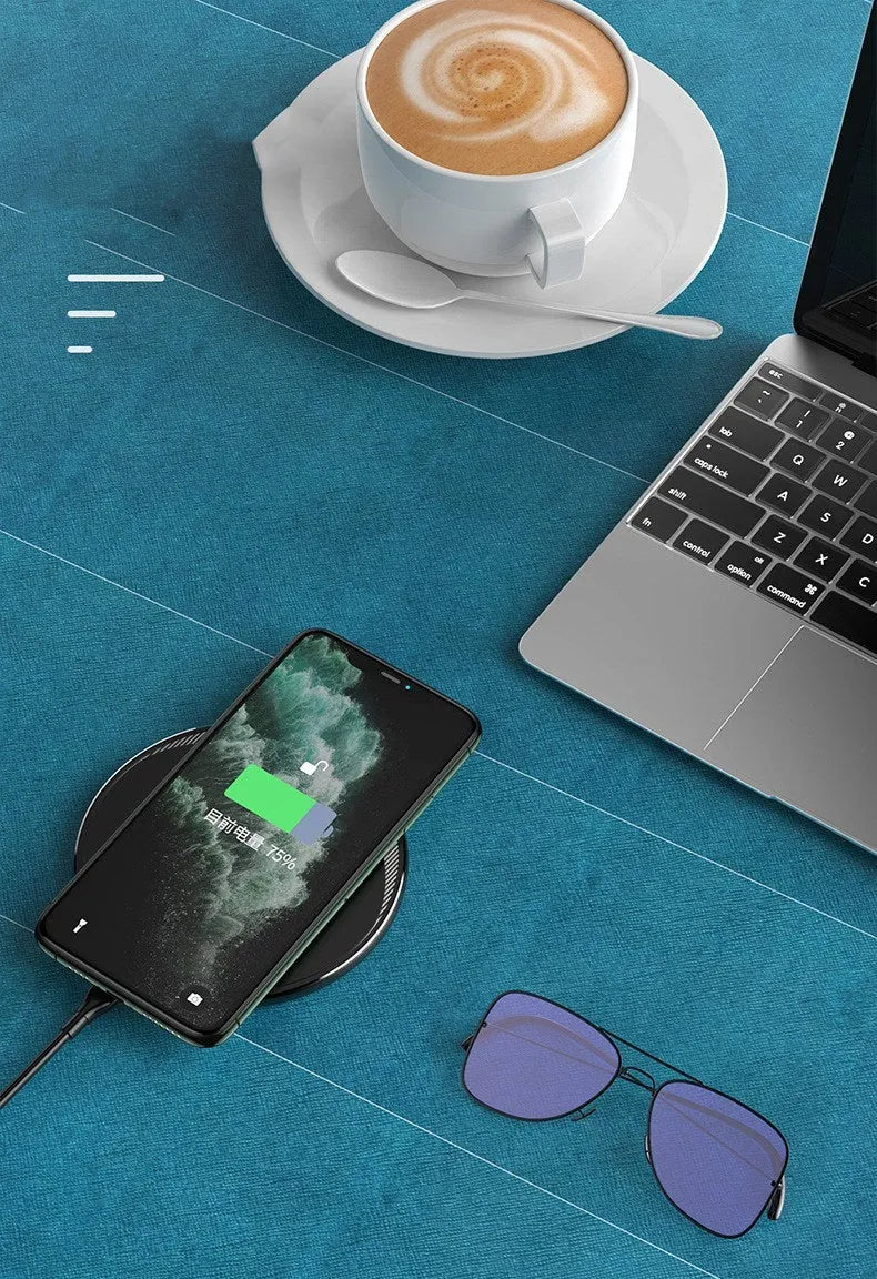 Black Kuulaa KL-CD16 wireless charging disc for mobile phones on a surface